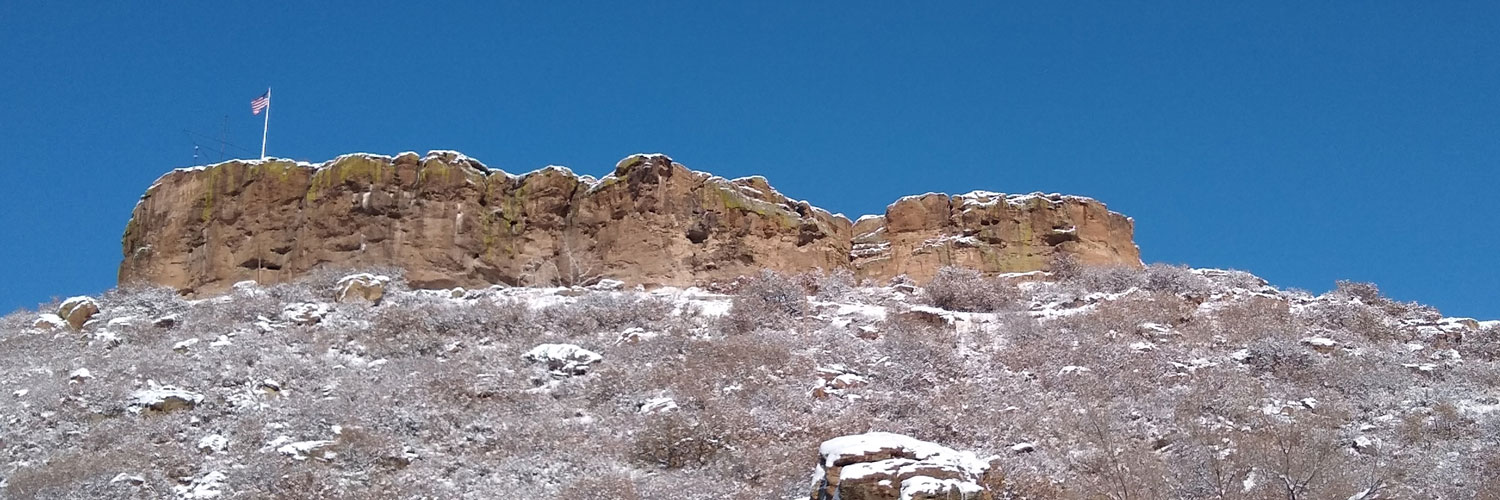 The Castle Rock with American flag on the summit Colorado Orthobiologics Regenerative Medicine Castle Rock CO